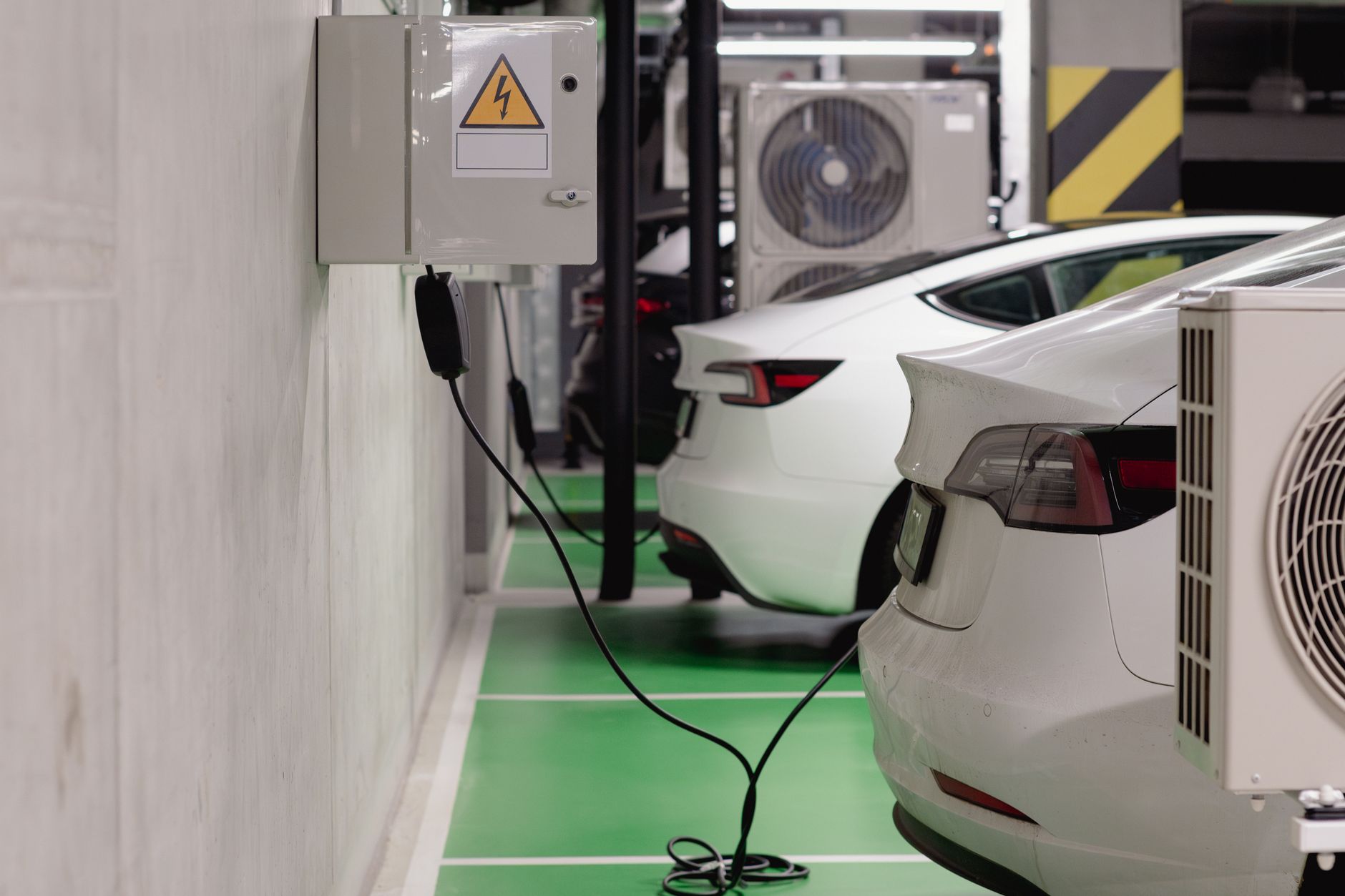 an electric vehicle plugged into a home garage charger