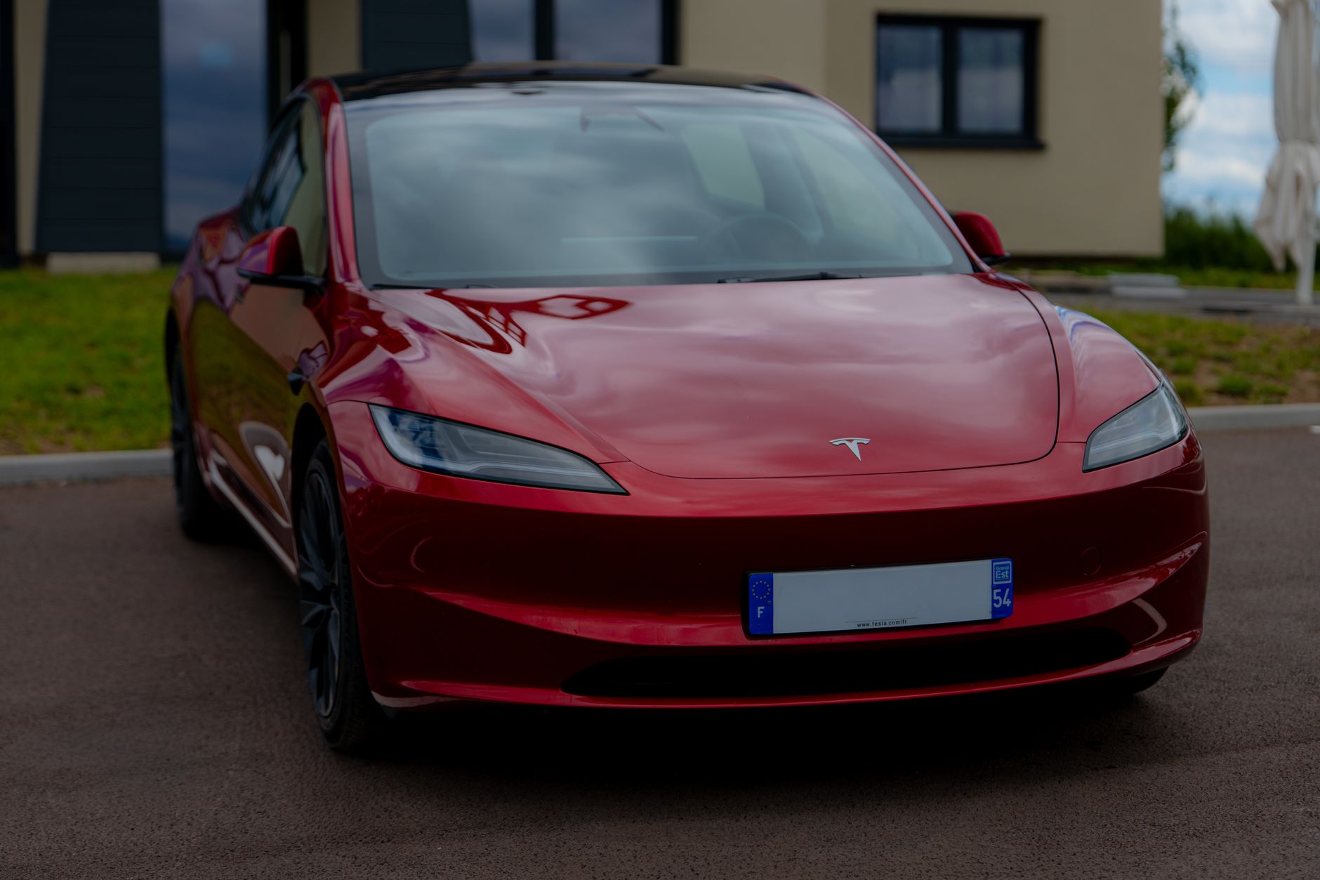 three electric vehicles parked side by side in a residential driveway